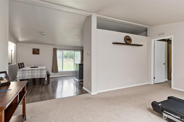 interior space featuring hardwood / wood-style floors and lofted ceiling