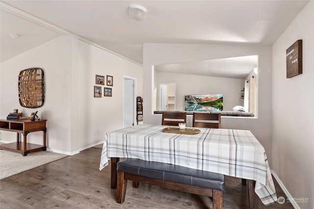 bedroom with lofted ceiling and hardwood / wood-style flooring