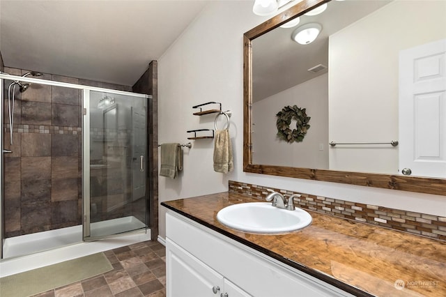 bathroom featuring vanity and a shower with shower door