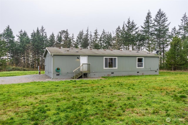 rear view of property with a yard