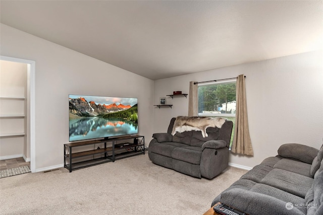 living room featuring carpet and vaulted ceiling