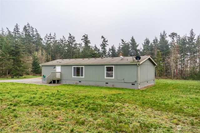 rear view of property featuring a yard