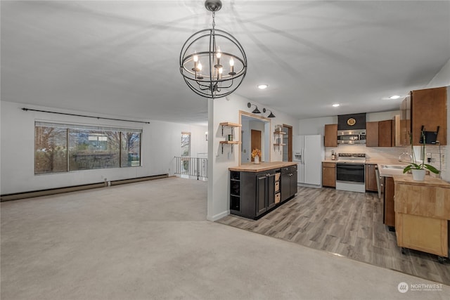 kitchen with electric stove, white refrigerator with ice dispenser, a baseboard radiator, stainless steel microwave, and a sink