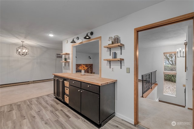 bathroom with baseboards, wood finished floors, vanity, and a notable chandelier