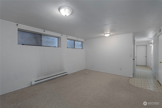 unfurnished room with baseboard heating and carpet flooring