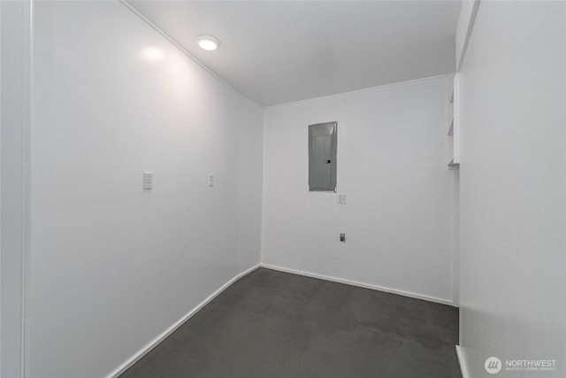 spare room featuring electric panel and baseboards