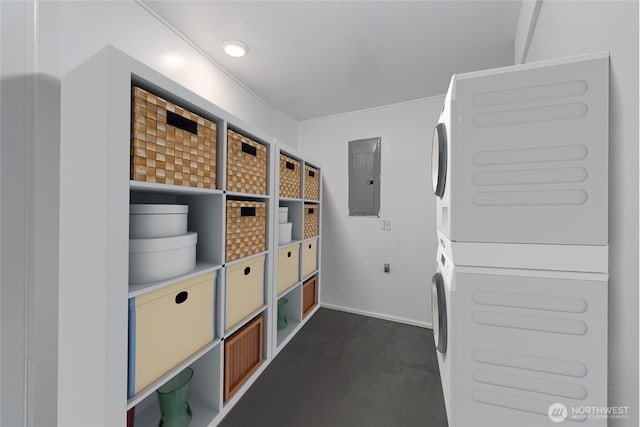 storage room with stacked washer and dryer and electric panel