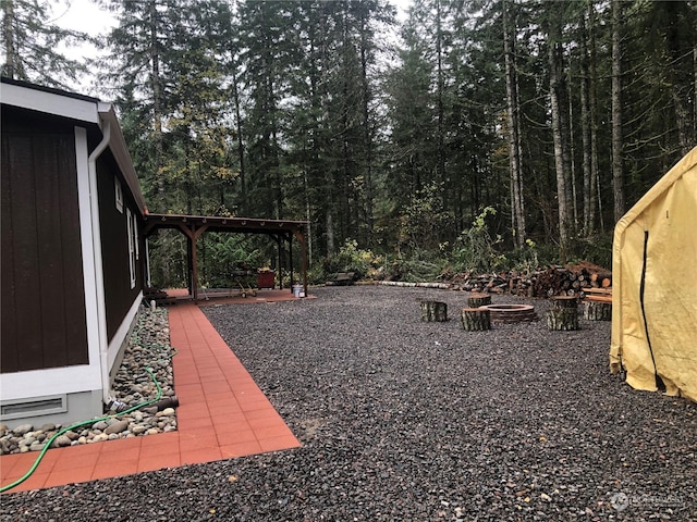 view of yard with a fire pit