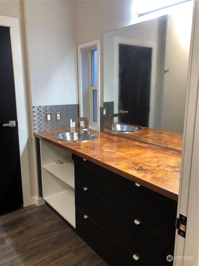 kitchen with butcher block countertops, backsplash, sink, and dark wood-type flooring