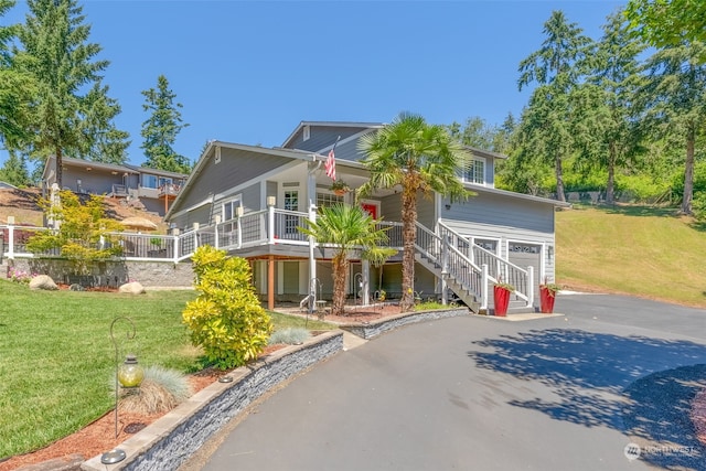 view of front of property with a porch and a front lawn