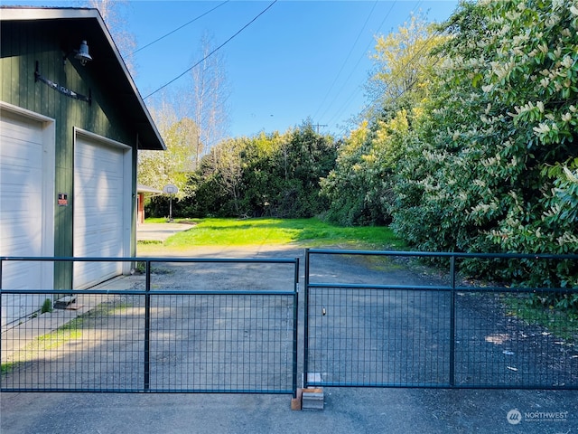 view of gate with a yard