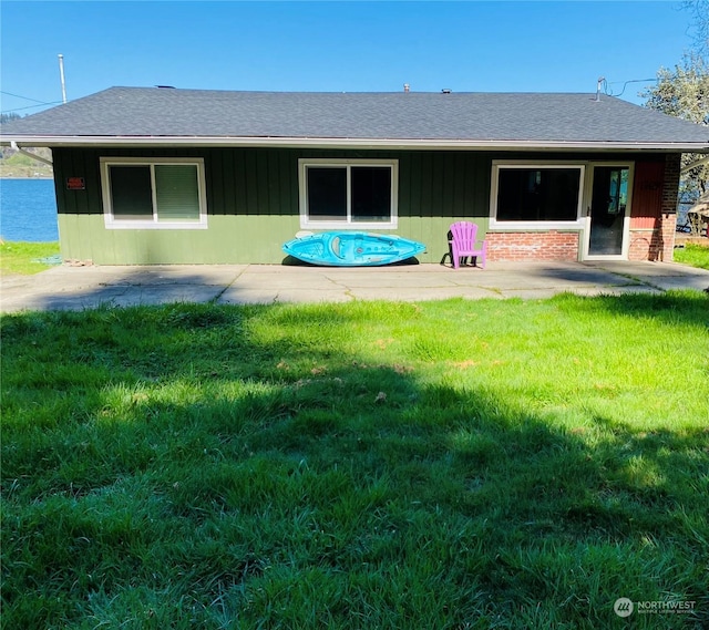 1769 SW Bay St, Port Orchard, WA 98366 - rear view of property with a patio, a shingled roof, and a yard