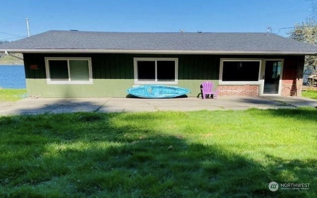 1769 SW Bay St, Port Orchard, WA 98366 - back of property featuring a yard, a patio area, and a shingled roof