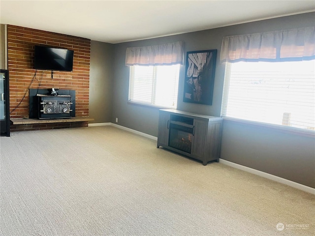 1769 SW Bay St, Port Orchard, WA 98366 - unfurnished living room with a brick fireplace, carpet floors, and baseboards