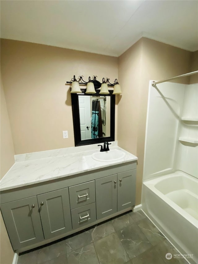 1769 SW Bay St, Port Orchard, WA 98366 - bathroom with vanity, marble look tile flooring, shower / bathtub combination, and baseboards