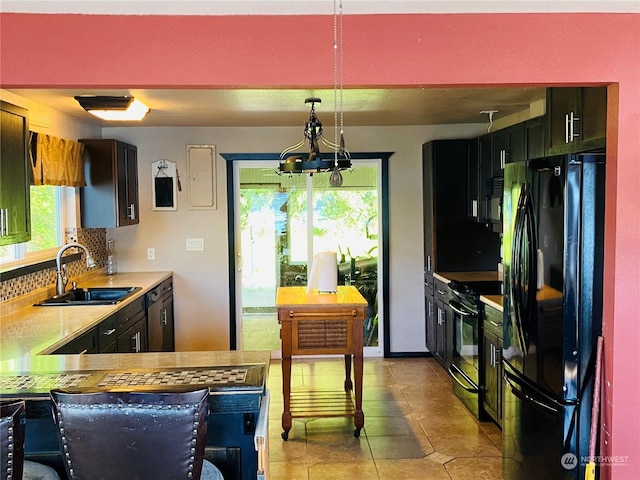 1769 SW Bay St, Port Orchard, WA 98366 - kitchen featuring black appliances, a sink, backsplash, light countertops, and a chandelier