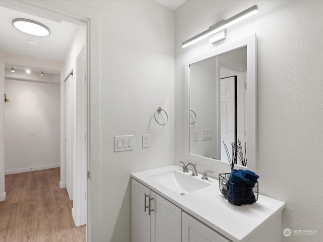 bathroom featuring vanity and hardwood / wood-style flooring