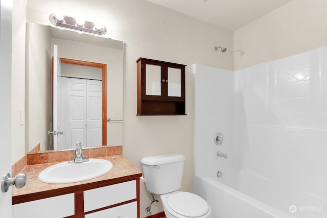 full bathroom with vanity, toilet, and  shower combination