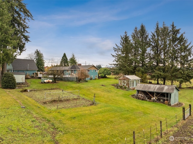 view of yard with an outdoor structure and a rural view