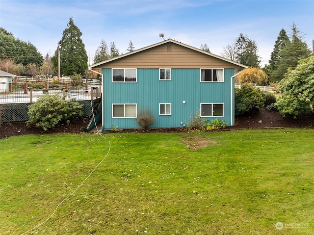 rear view of property with a lawn