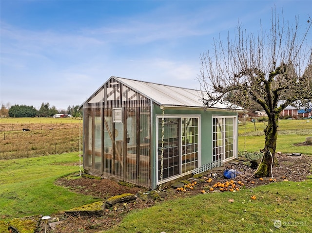 view of outdoor structure featuring a lawn