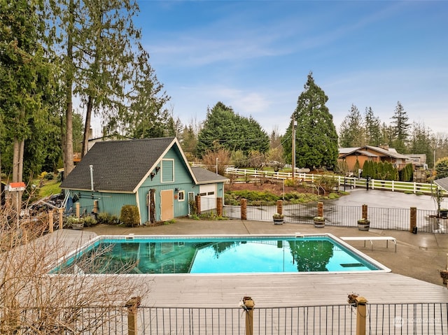 view of pool featuring a diving board and a patio