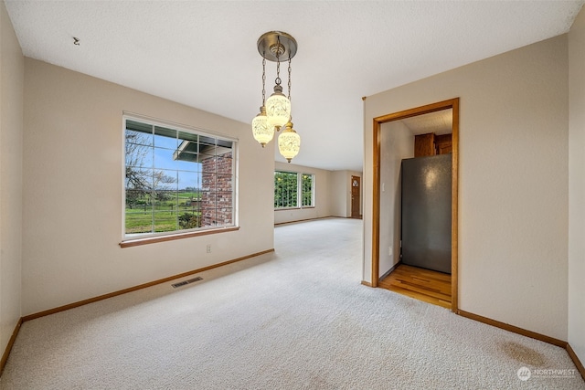 unfurnished dining area with carpet floors