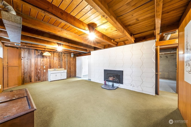 basement with wood ceiling, wooden walls, and carpet flooring