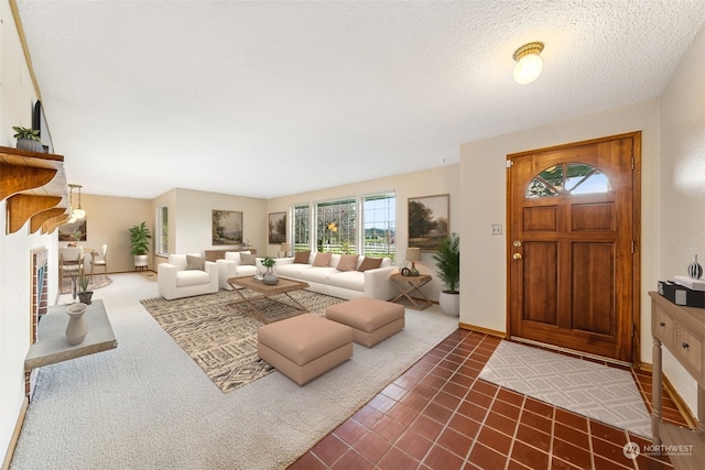 carpeted entryway with a textured ceiling