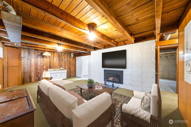 living room with wood ceiling, wooden walls, beam ceiling, and light carpet