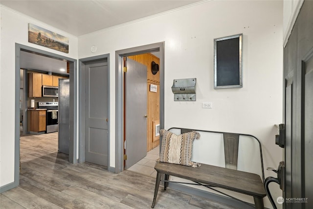 corridor featuring light hardwood / wood-style flooring and ornamental molding