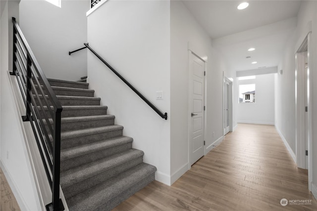 stairs featuring hardwood / wood-style flooring