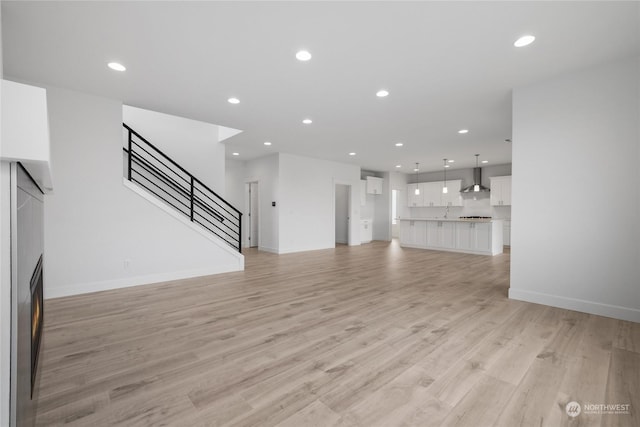 unfurnished living room with light hardwood / wood-style floors