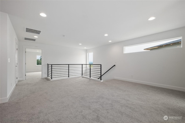 carpeted spare room with plenty of natural light