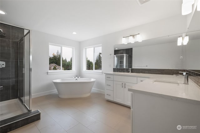 bathroom with tile patterned floors, vanity, and independent shower and bath