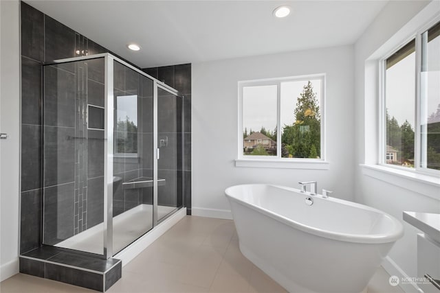 bathroom featuring tile patterned flooring and independent shower and bath