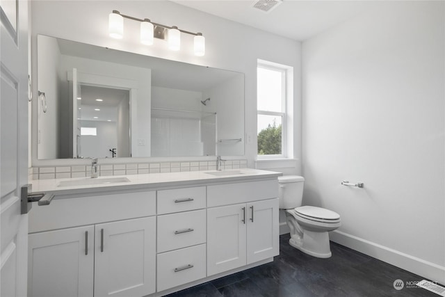 bathroom with backsplash, walk in shower, vanity, hardwood / wood-style floors, and toilet