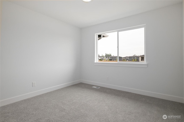 unfurnished room featuring carpet