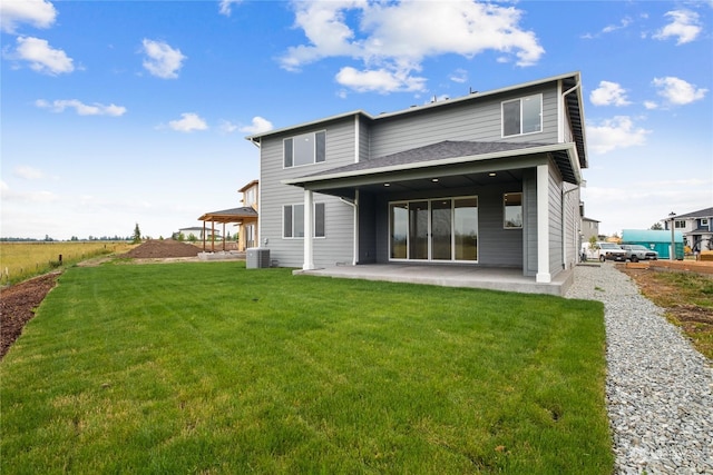 back of house featuring a yard, central AC, and a patio area