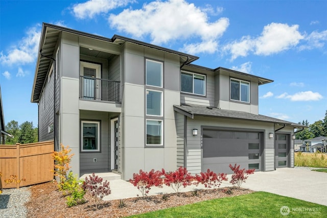 6202 229th Ave E, Buckley, WA 98321 - view of front of property featuring a balcony, driveway, a garage, and stucco siding