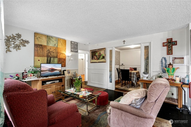 living room featuring hardwood / wood-style floors and a textured ceiling