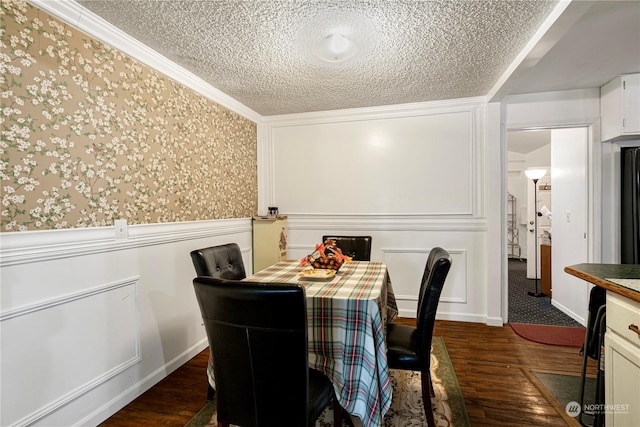 dining area featuring crown molding, dark hardwood / wood-style flooring, and a textured ceiling