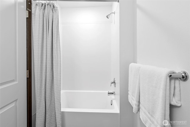 bathroom with shower / bath combination with curtain