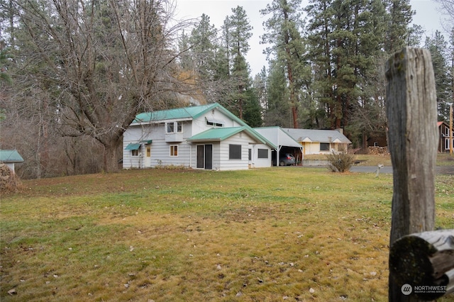 view of front facade with a front yard and a carport