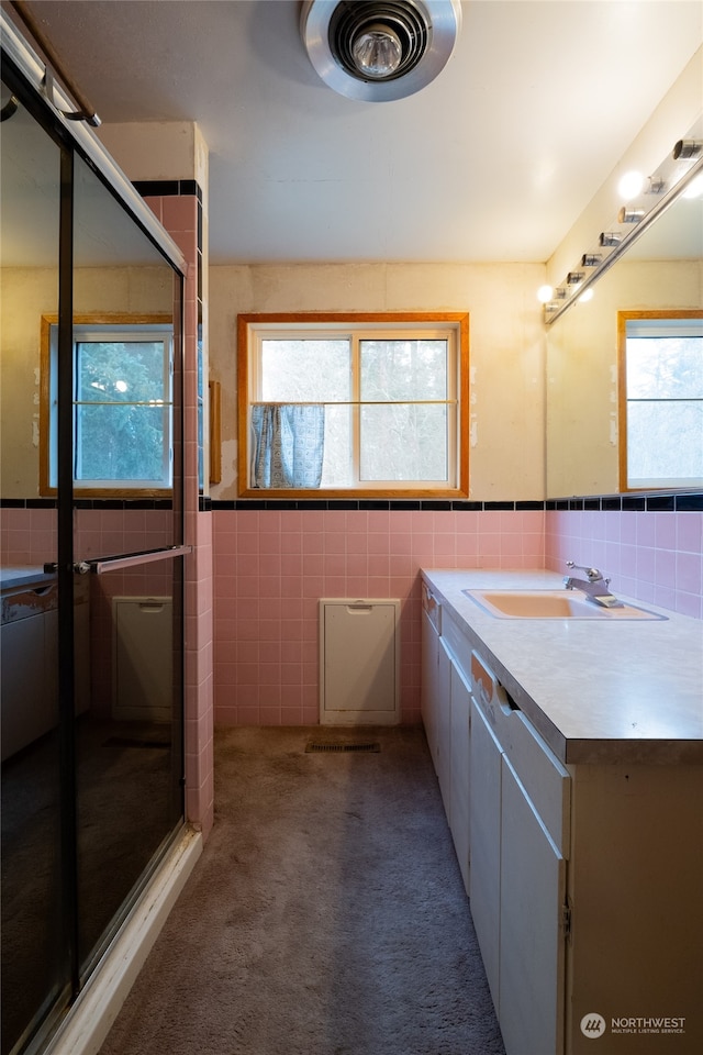 bathroom featuring a wealth of natural light and tile walls