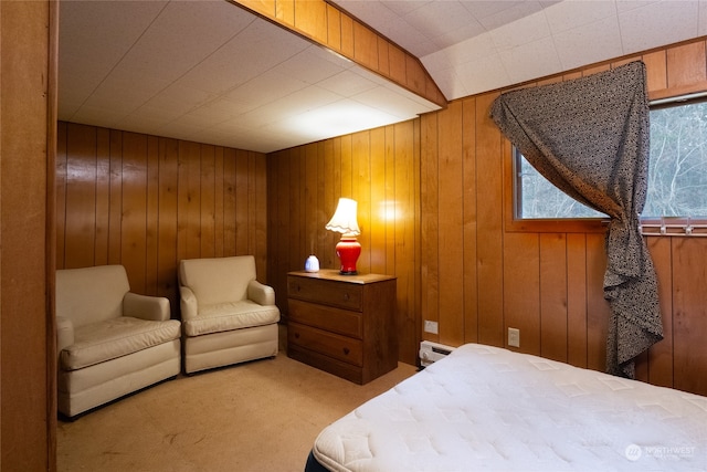 carpeted bedroom featuring a baseboard radiator and wood walls