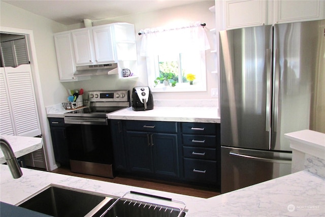 1427 100th St SW Unit 97, Everett, WA 98204 - kitchen with appliances with stainless steel finishes, under cabinet range hood, white cabinetry, light stone countertops, and open shelves
