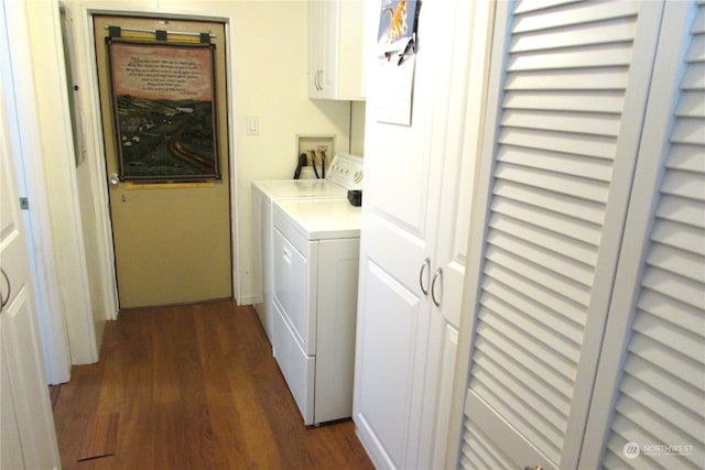 laundry room featuring cabinets, dark wood-type flooring, and washing machine and clothes dryer