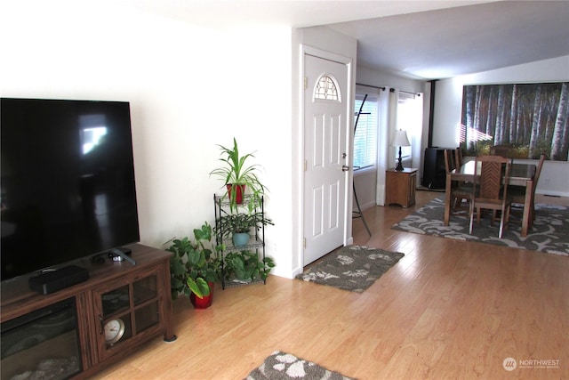 foyer entrance featuring hardwood / wood-style flooring and vaulted ceiling