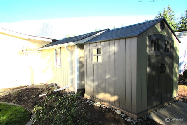 view of property exterior with a shed